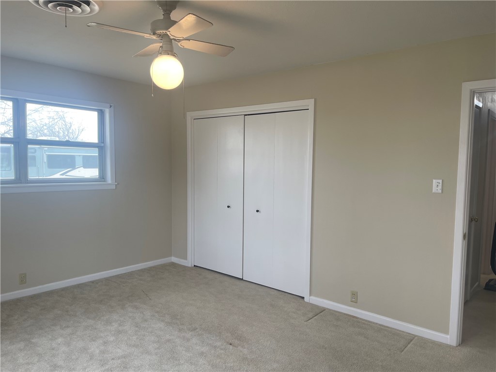 1008 North Bosque Street Meridian, TX 76665 - Photo 18 of 36 an empty room with windows and fan