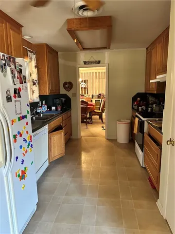 a kitchen with granite countertop a refrigerator and a stove