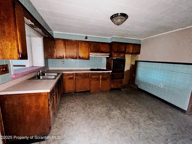 a kitchen that has a sink and a stove