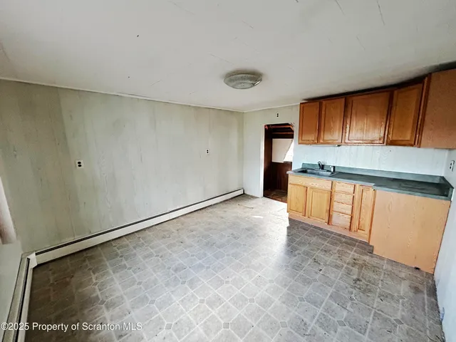 a view of a kitchen with a sink and cabinets
