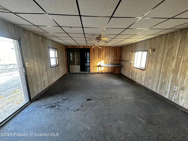 a view of a livingroom with an empty space and a window