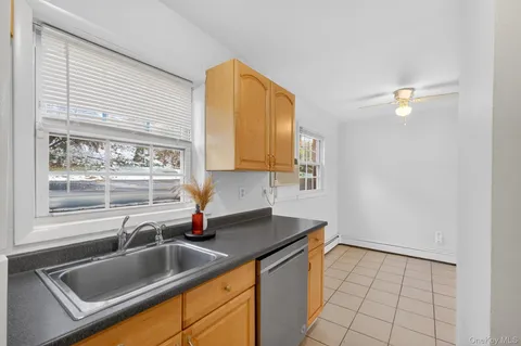 a kitchen with a sink cabinets and window