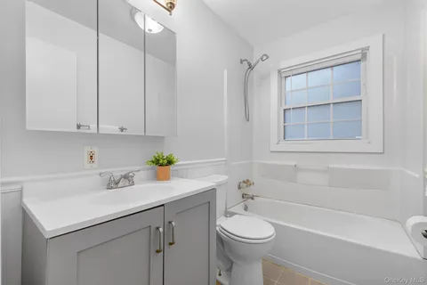 a bathroom with a sink a toilet and bathtub