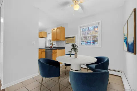 a view of a dining room with furniture and a lamp