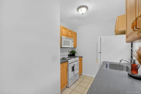 a kitchen with a sink a stove and a microwave