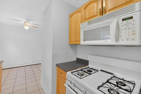 a stove top oven sitting inside of a kitchen