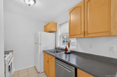 a kitchen with stainless steel appliances a sink a stove and a window