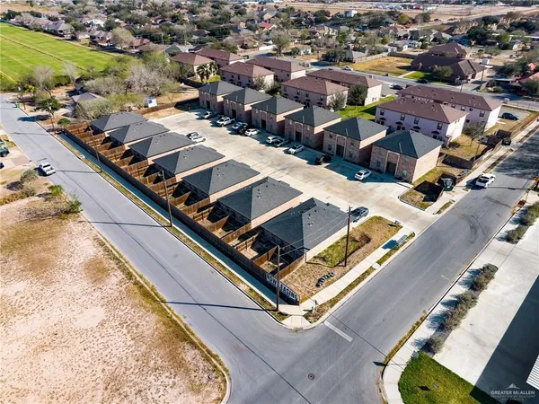 an aerial view of a residential houses with outdoor space