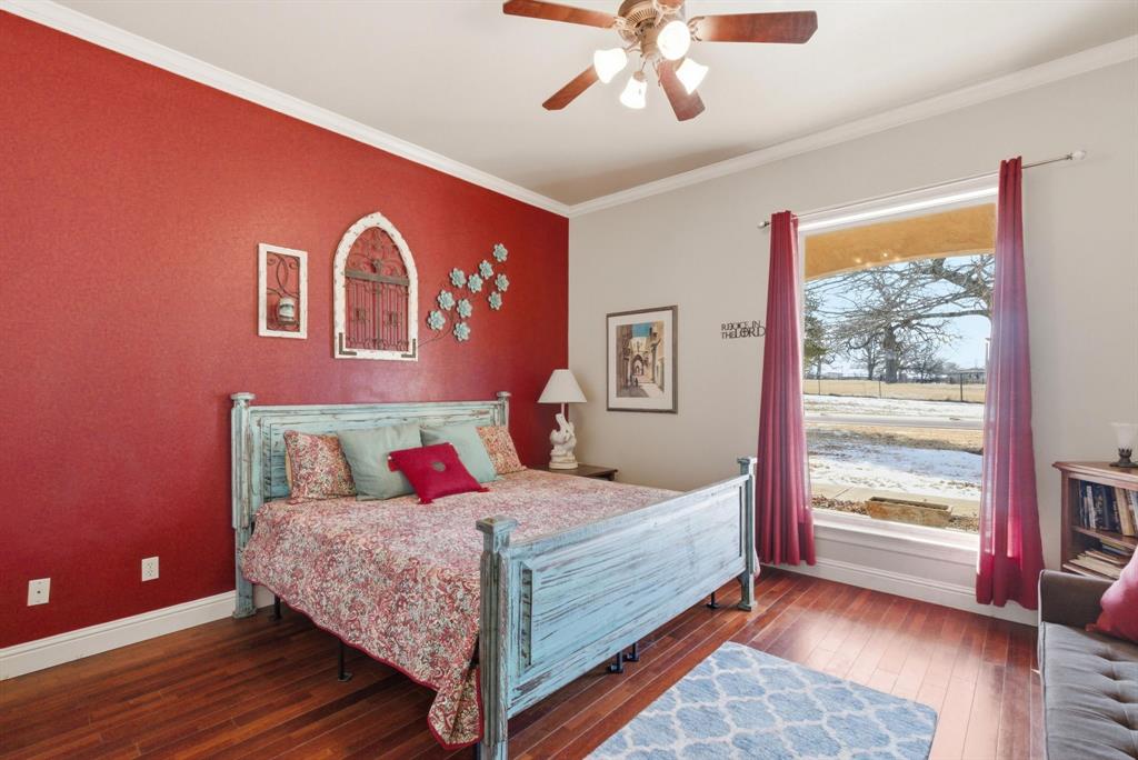 3601 Springfield Road Springtown, TX 76082 - Photo 13 of 40 a bedroom with a large bed and a window