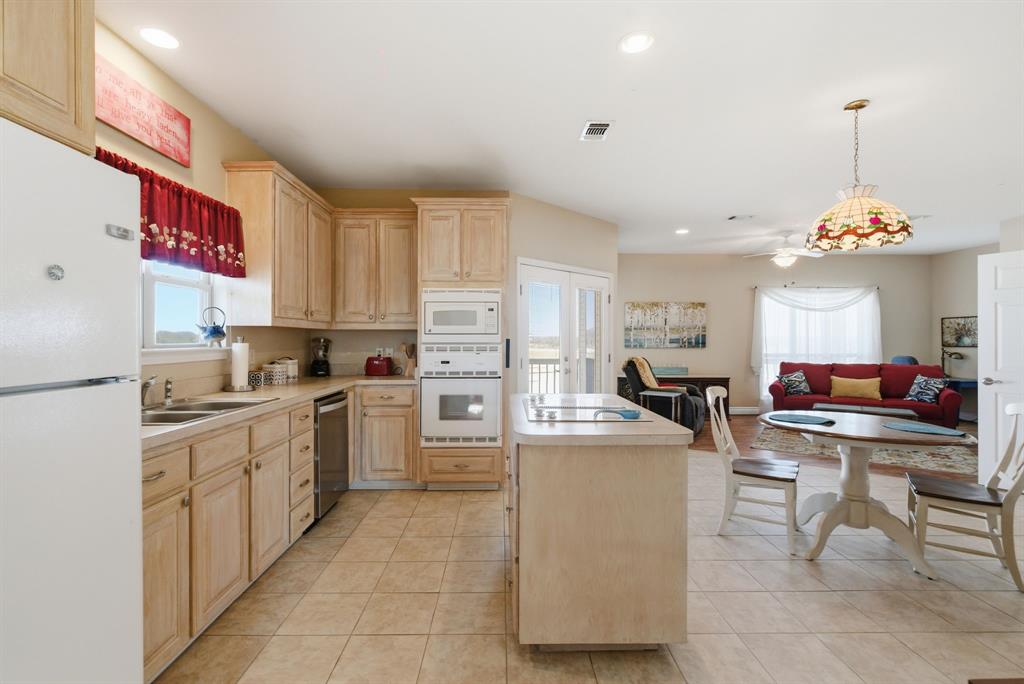 3601 Springfield Road Springtown, TX 76082 - Photo 18 of 40 a kitchen that has a lot of white cabinets and stainless steel appliances