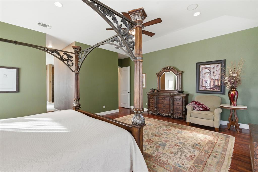 3601 Springfield Road Springtown, TX 76082 - Photo 29 of 40 a bedroom with a bed a dresser and paintings on the wall