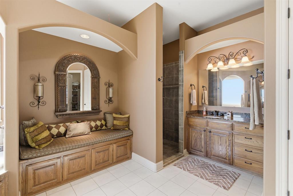 3601 Springfield Road Springtown, TX 76082 - Photo 30 of 40 a spacious bathroom with a granite countertop sink a large mirror and a shower