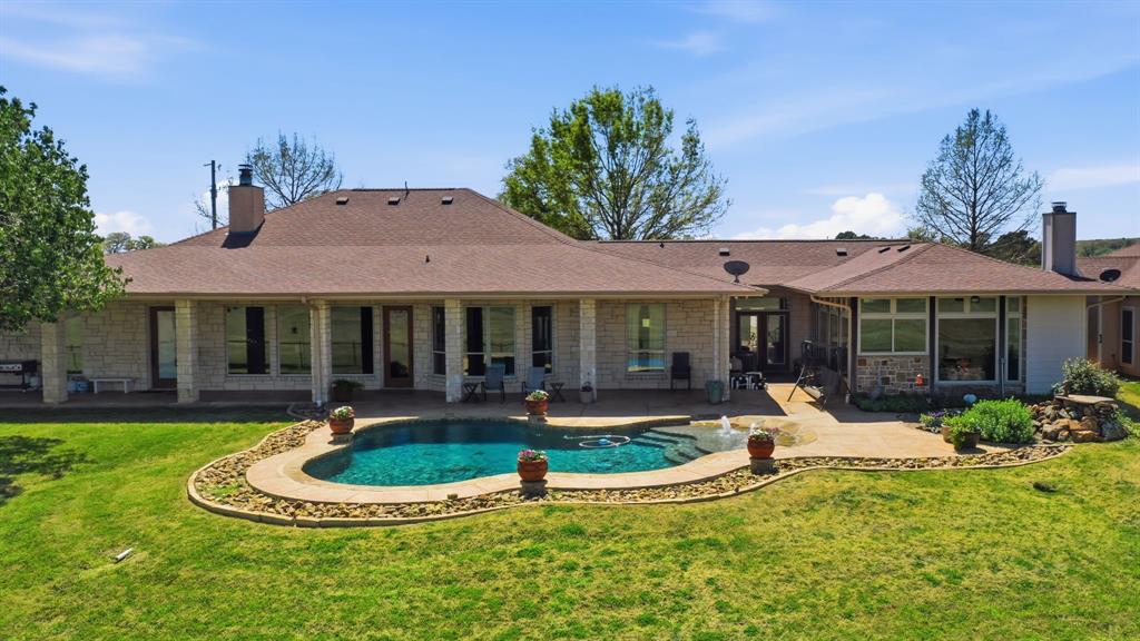 3601 Springfield Road Springtown, TX 76082 - Photo 34 of 40 a front view of a house with garden and patio