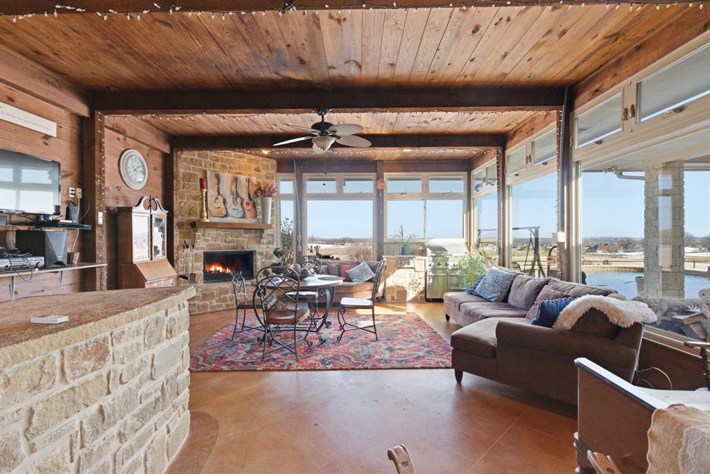3601 Springfield Road Springtown, TX 76082 - Photo 8 of 40 a living room with furniture a fireplace and a table