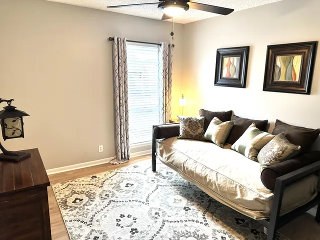 a living room with a bed and a couch