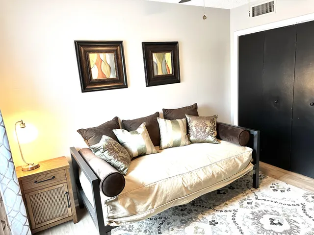 a bedroom with a bed and wall painting