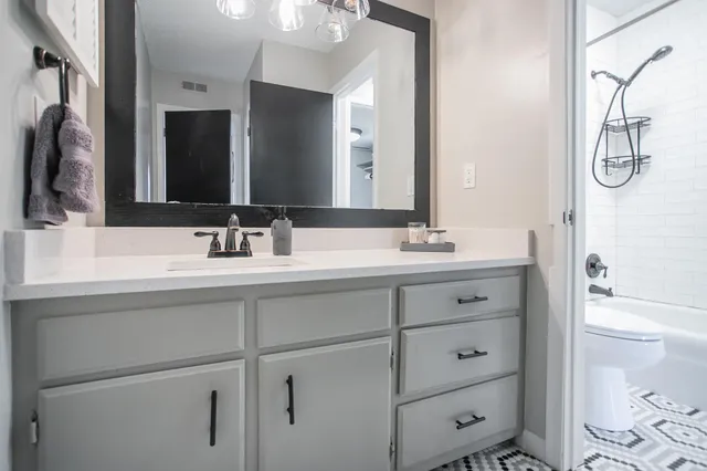 a bathroom with a double vanity sink and a mirror