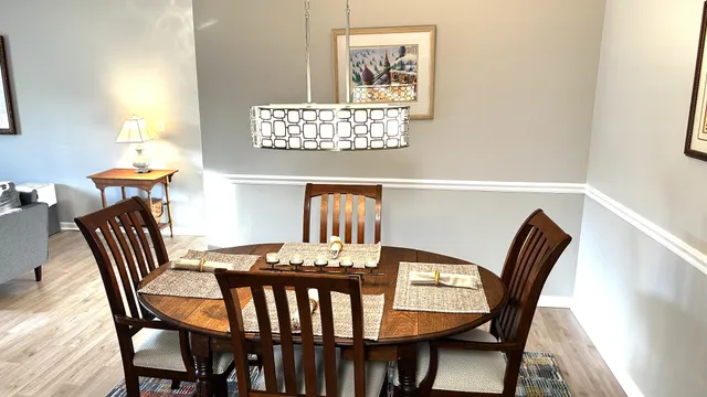 a view of a dining room with furniture and wooden floor