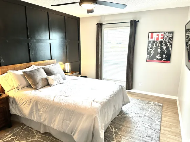 a bedroom with a bed and a window