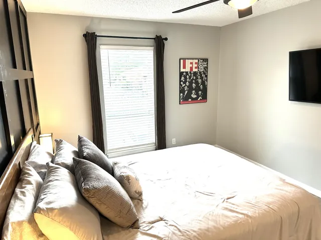 a bedroom with a bed and a flat screen tv