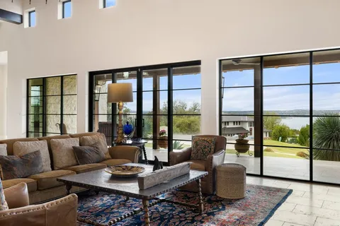 a kitchen with stainless steel appliances a dining table chairs microwave and stove