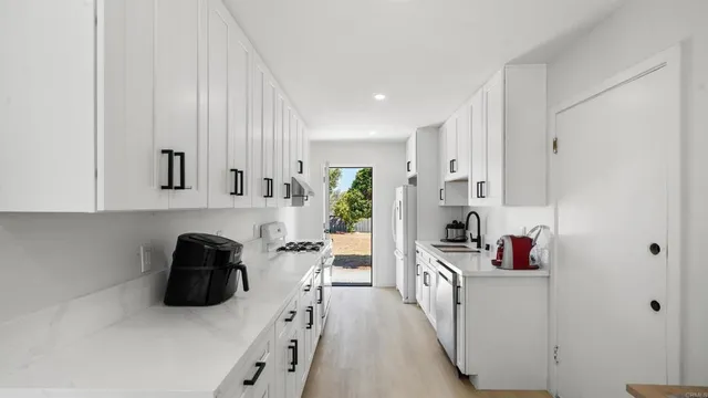 a kitchen with stainless steel appliances granite countertop a sink and cabinets