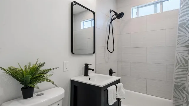 a bathroom with a sink a mirror and a shower
