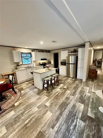 a room with a washing machine and wooden floor