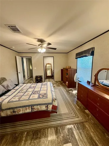 a spacious bedroom with a bed and a dresser