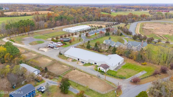 an aerial view of residential houses with outdoor space and parking