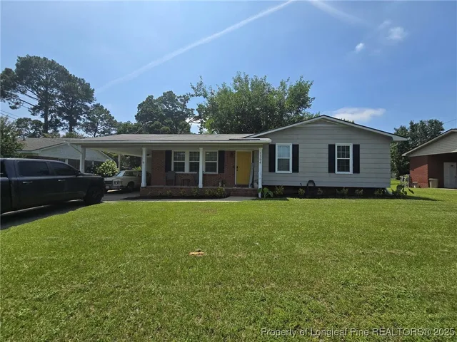 a view of an house with backyard space and garden