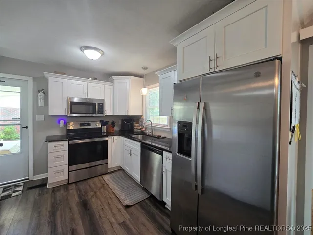a kitchen with a refrigerator a sink and dishwasher