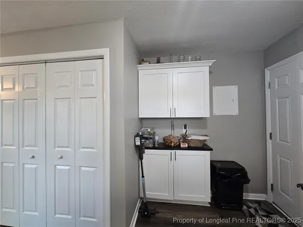 a kitchen with dining table chairs and refrigerator