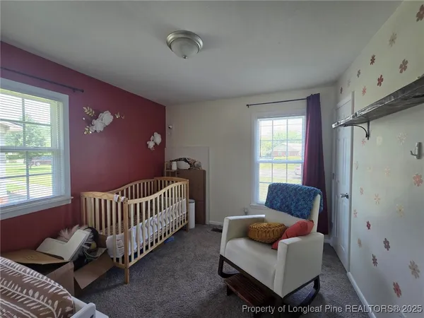 a bedroom with furniture and a window