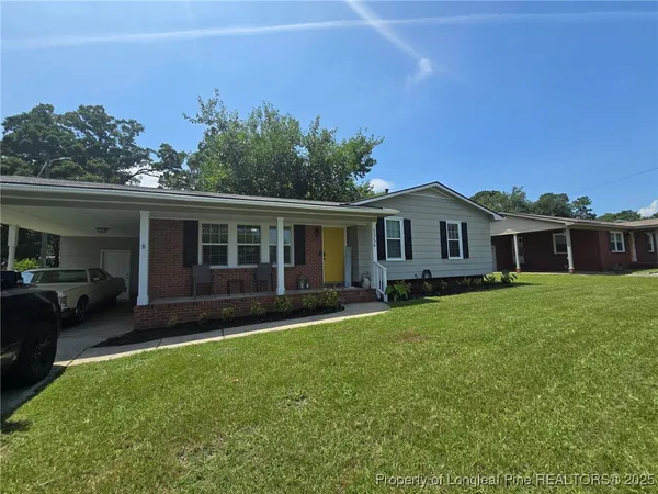 a front view of a house with a garden