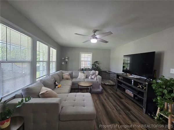 a living room with furniture and a flat screen tv
