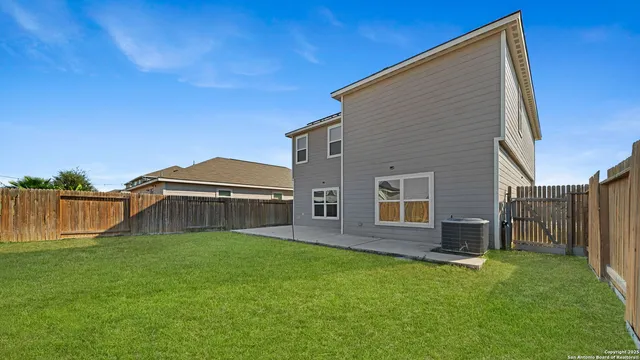a view of a house with a backyard