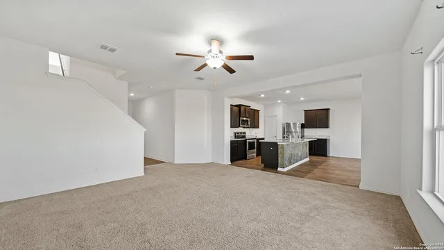 a view of a kitchen with furniture and a ceiling fan