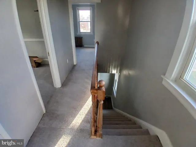 a view of entryway and hallway with wooden floor