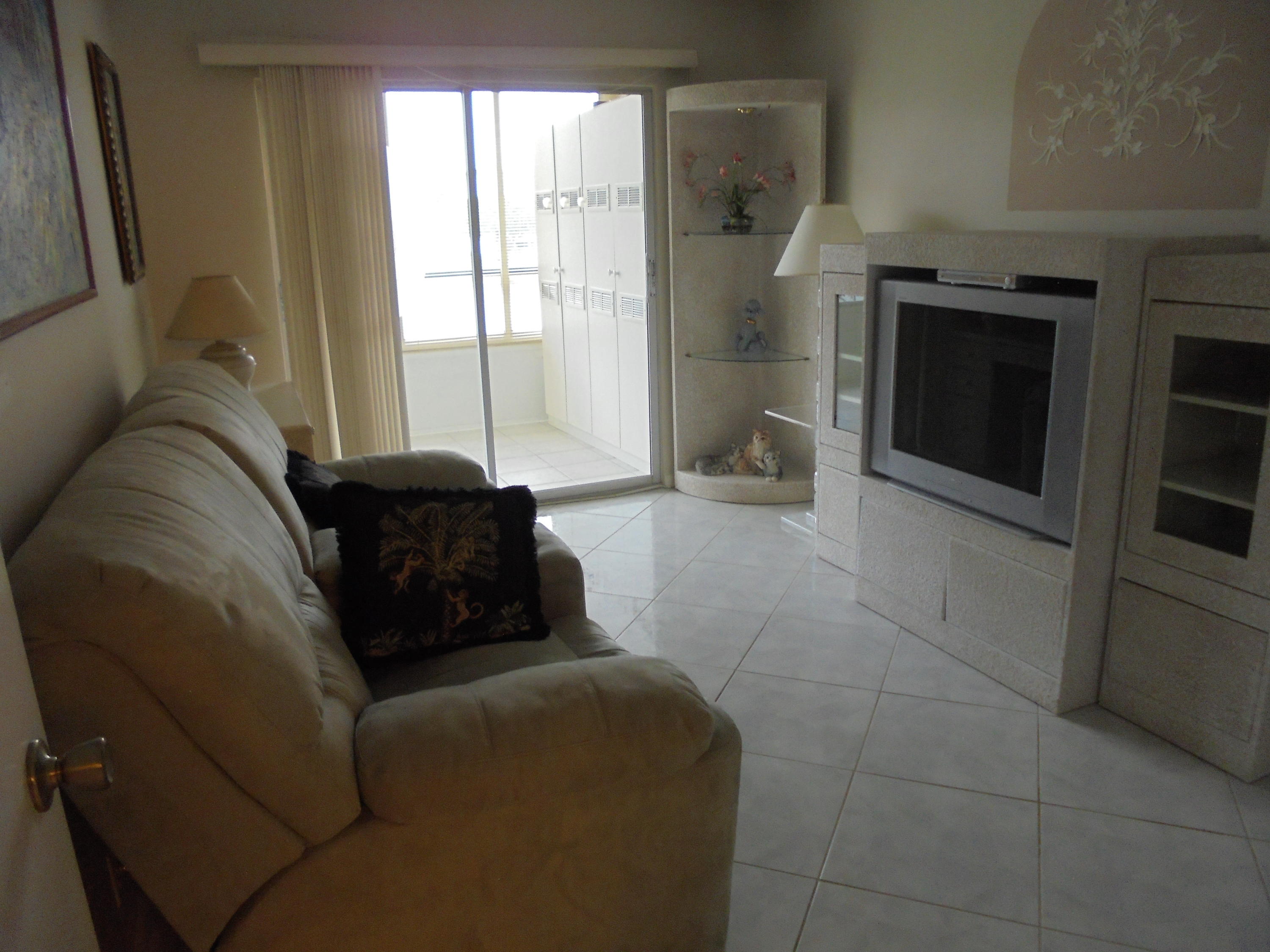 2028 Hythe B Boca Raton, FL 33434 - Photo 11 of 15 a living room with a couch and a stove top oven