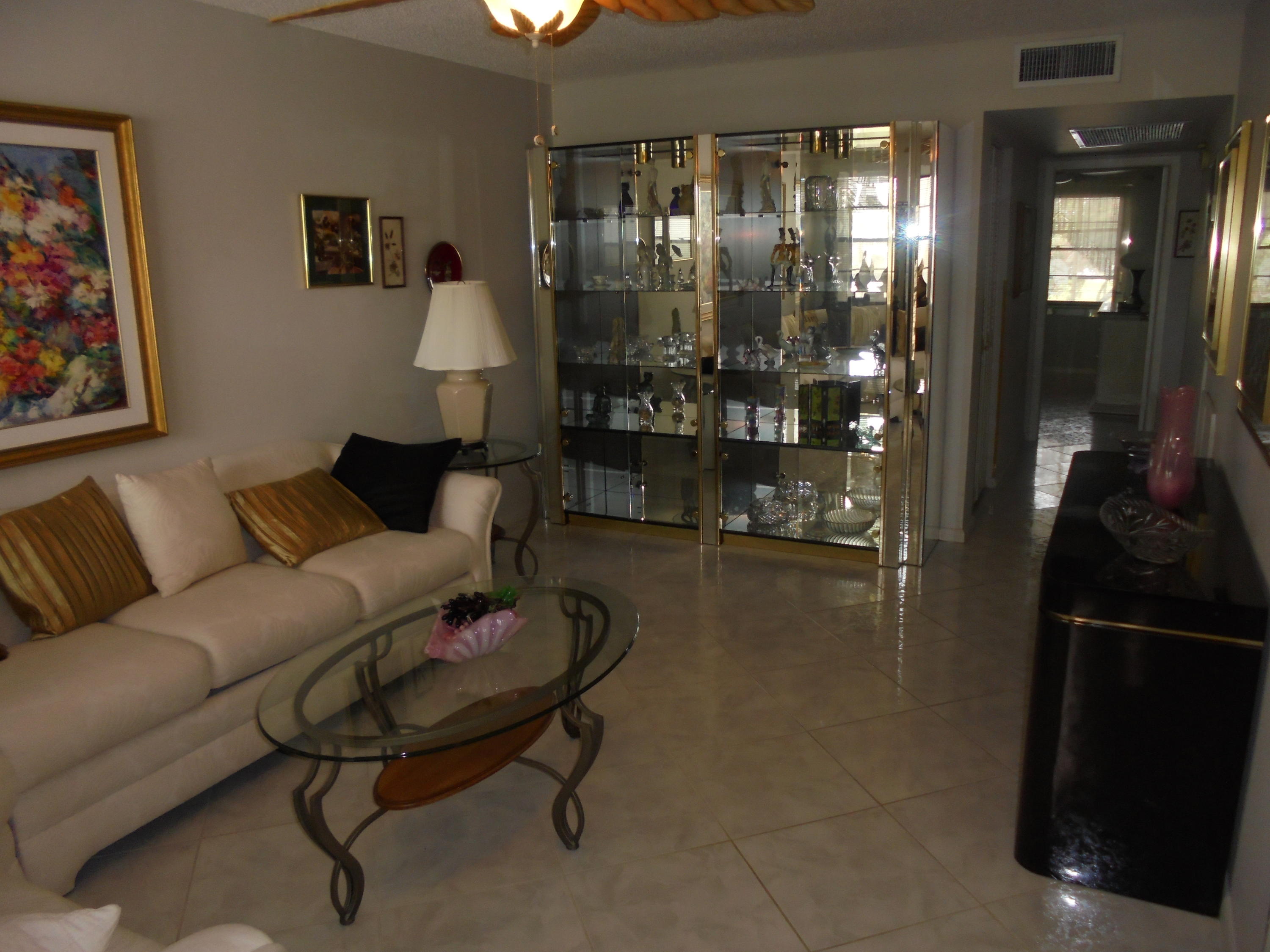 2028 Hythe B Boca Raton, FL 33434 - Photo 5 of 15 a living room with furniture a lamp and a window