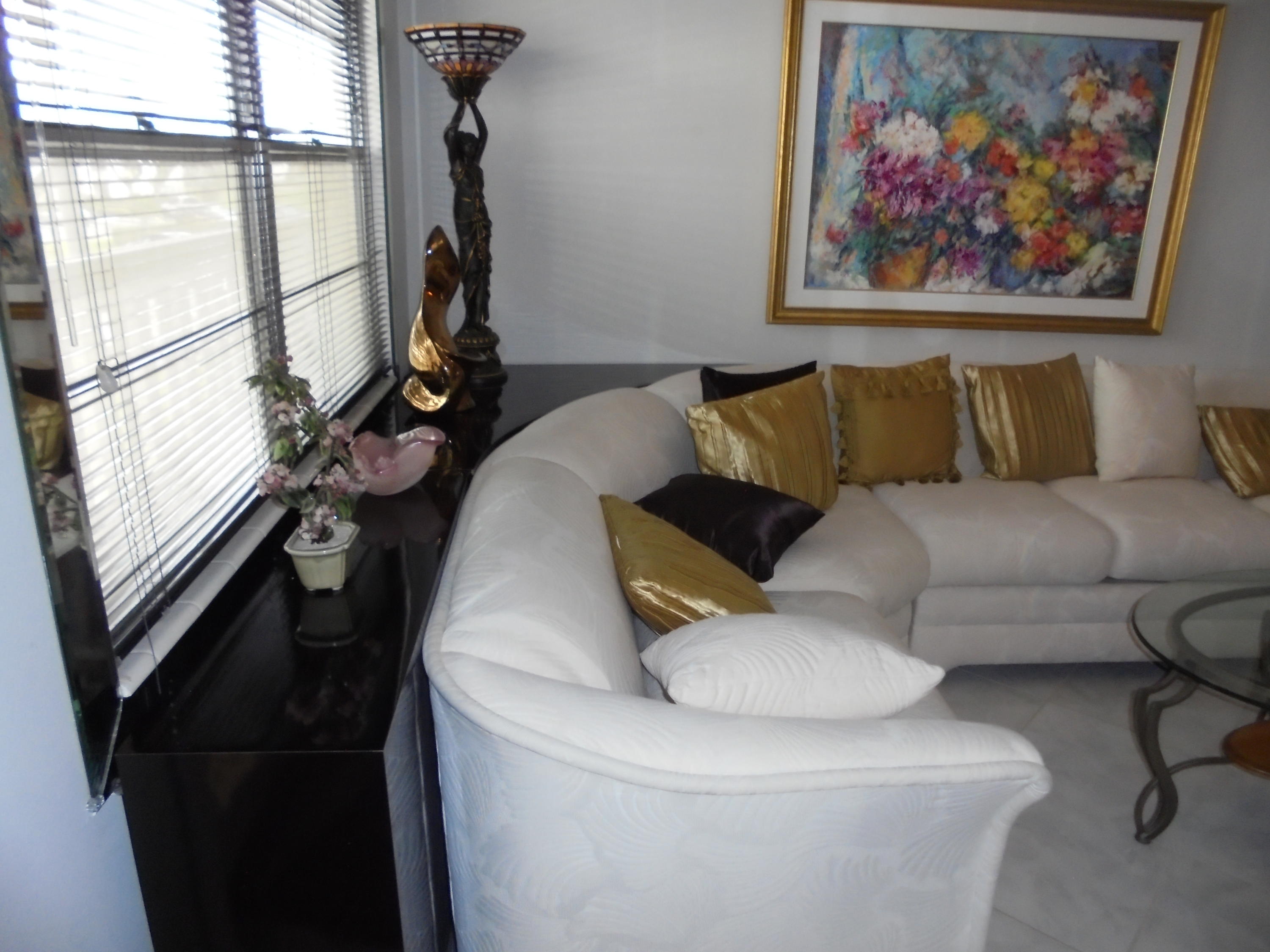 2028 Hythe B Boca Raton, FL 33434 - Photo 6 of 15 a living room with furniture a window and a chandelier