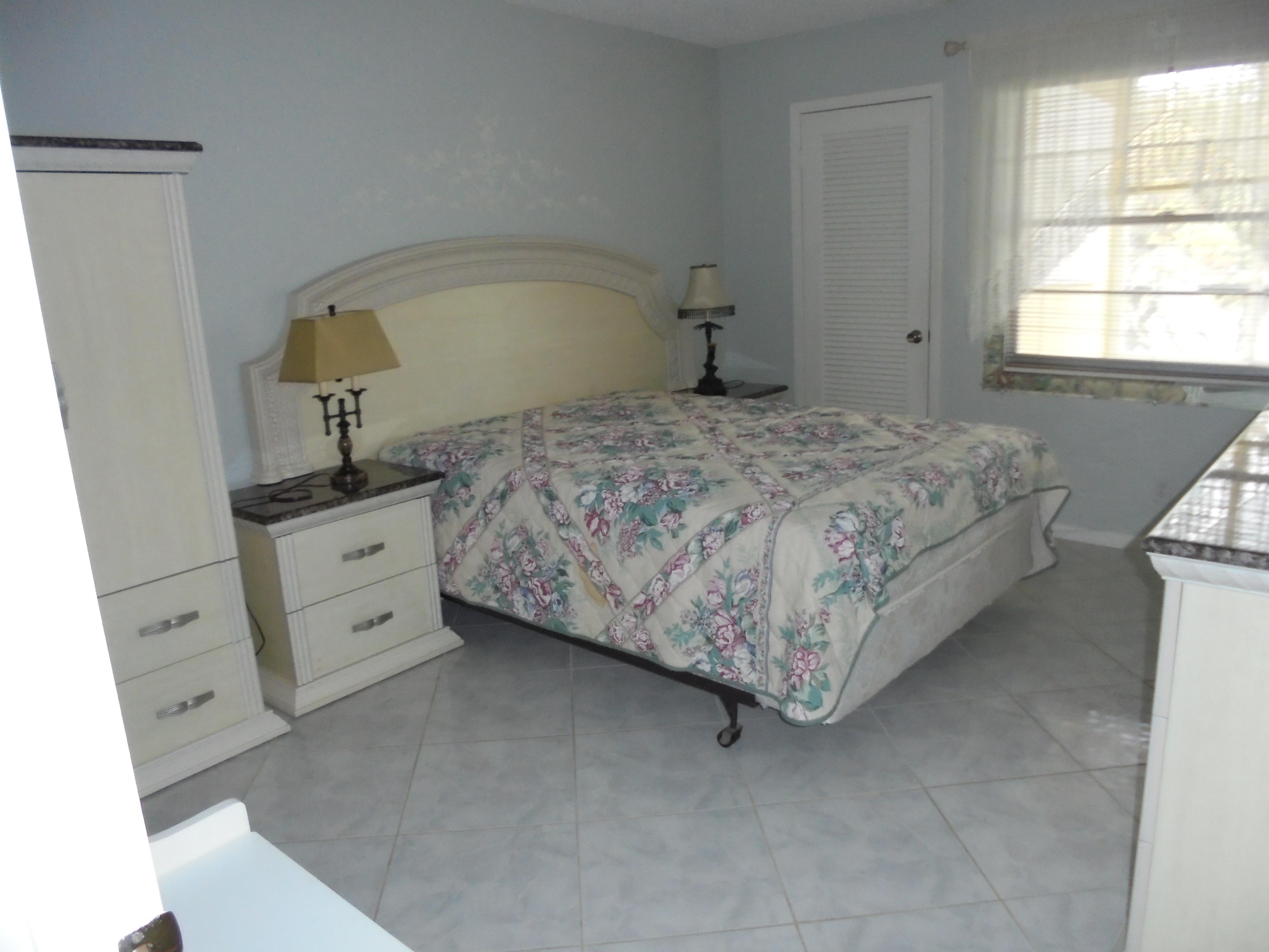 2028 Hythe B Boca Raton, FL 33434 - Photo 7 of 15 a bedroom with a bed and a window