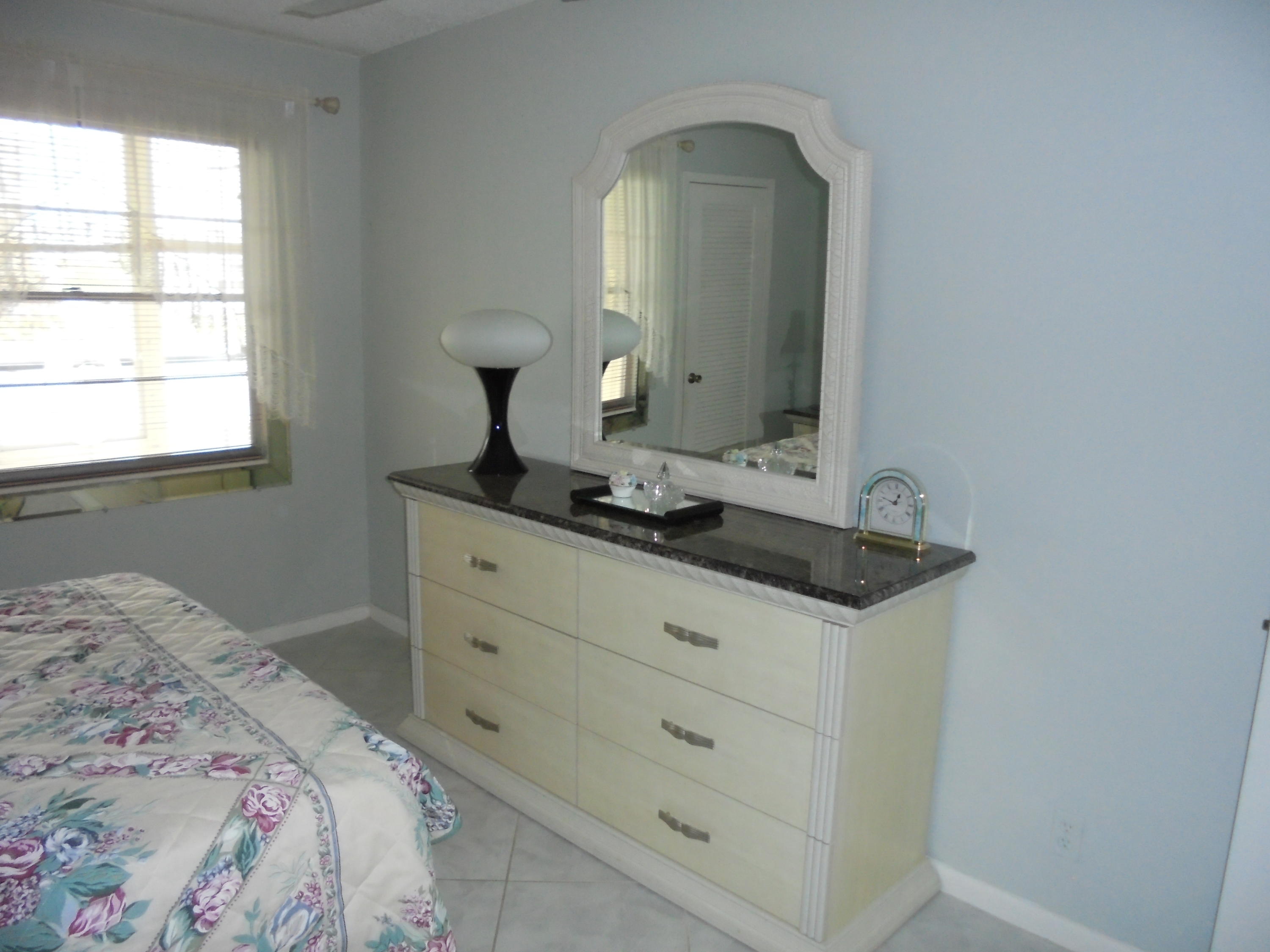 2028 Hythe B Boca Raton, FL 33434 - Photo 8 of 15 a bedroom with a bed and a mirror