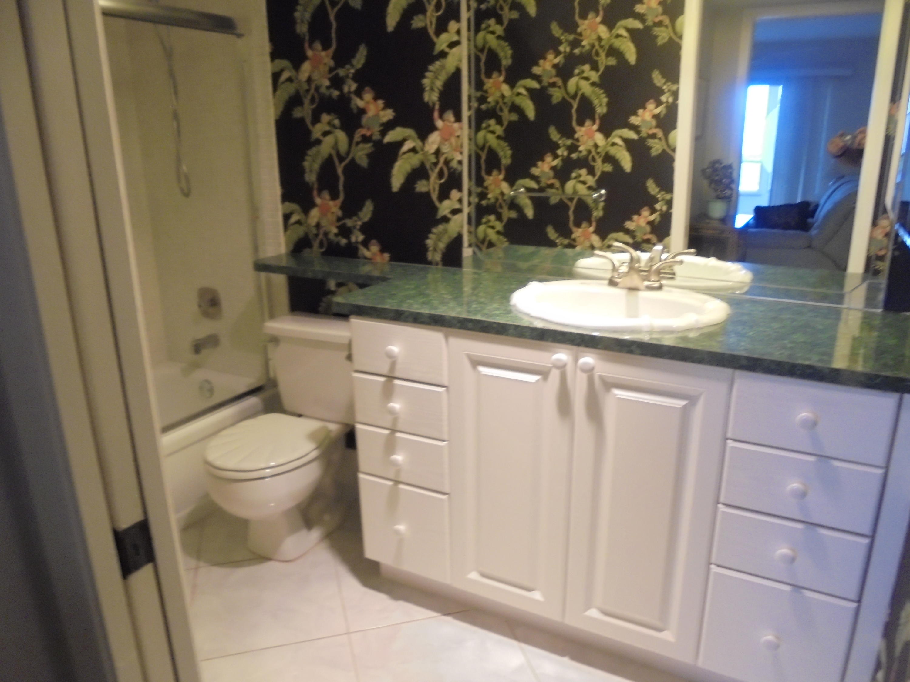 2028 Hythe B Boca Raton, FL 33434 - Photo 10 of 15 a bathroom with a sink and a mirror