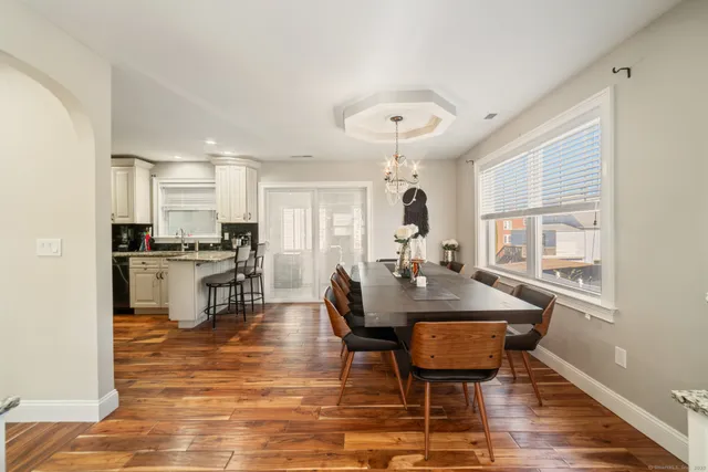 a view of a dining room with furniture and wooden floor