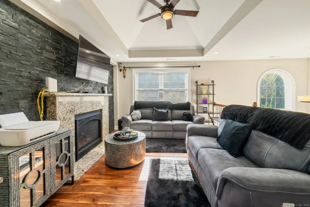 a living room with furniture a fireplace and a flat screen tv