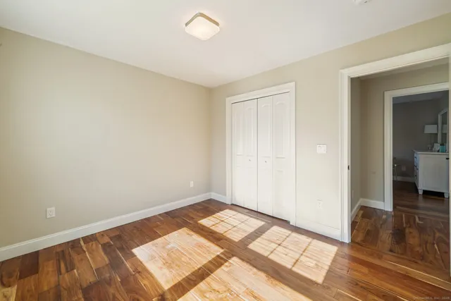 a view of an empty room and wooden floor