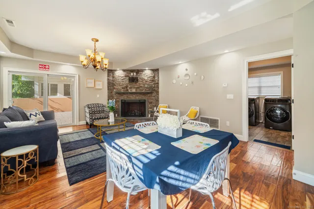 a living room with furniture a dining table and a fireplace