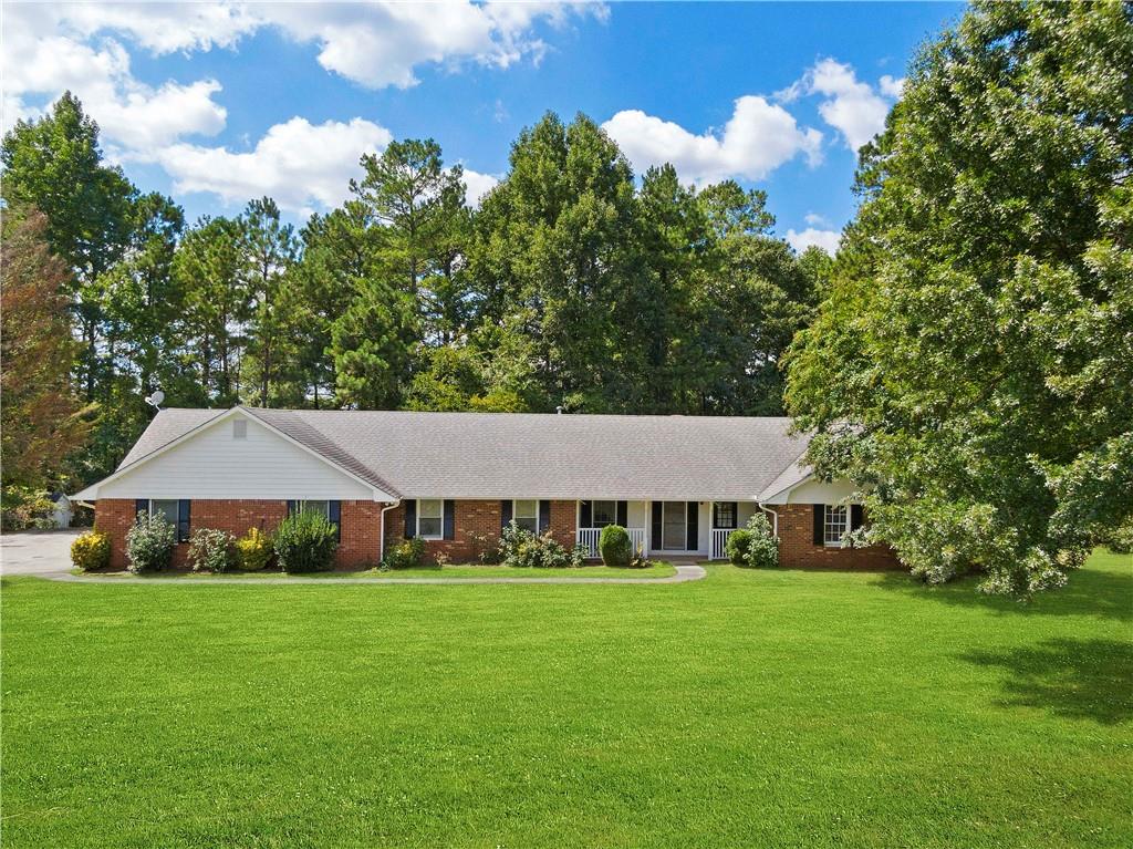 273 Austin Road Stockbridge, GA 30281 - Photo 1 of 1 a aerial view of a white house with a big yard plants and large trees